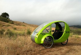 Electric-assist tricycle with solar panel on roof. (OrganicTransit.com)